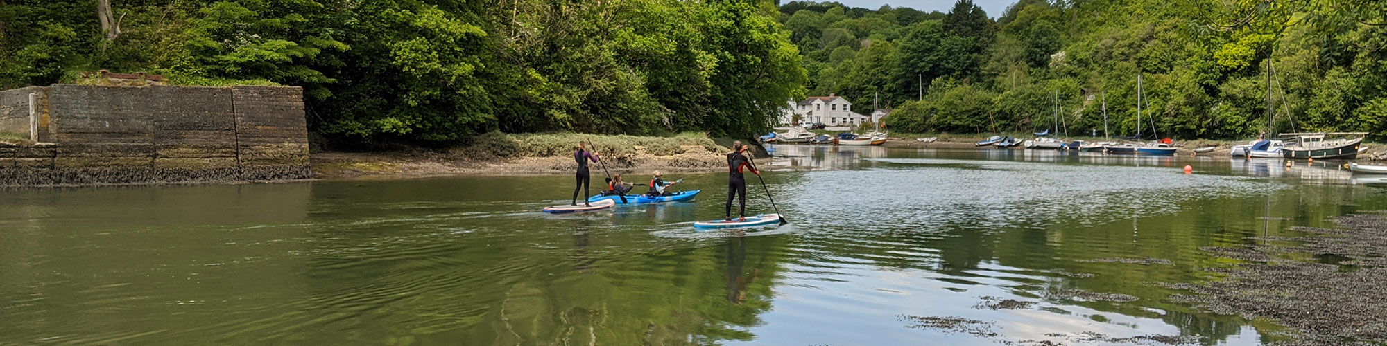 Image of a family paddleboarding on the Lynher river