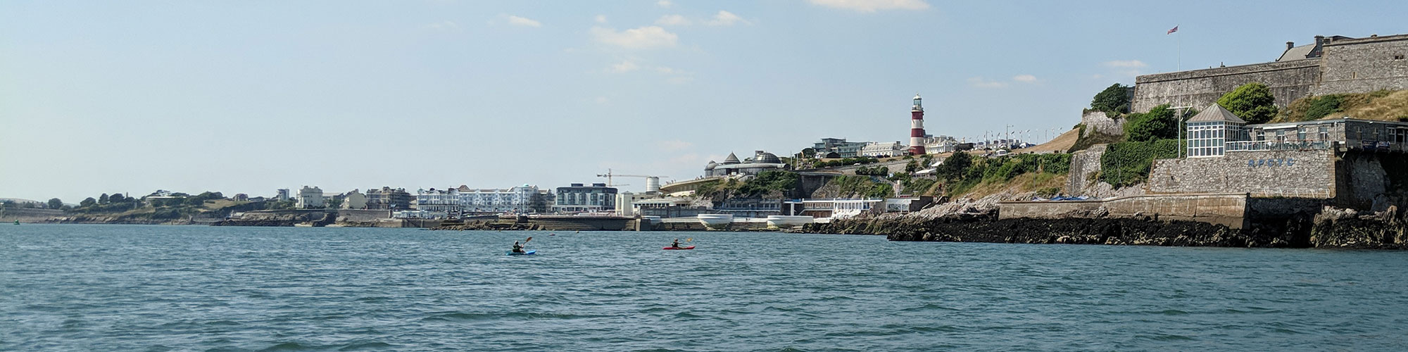 Image of Plymouth sound with two kayakers in the foreground
